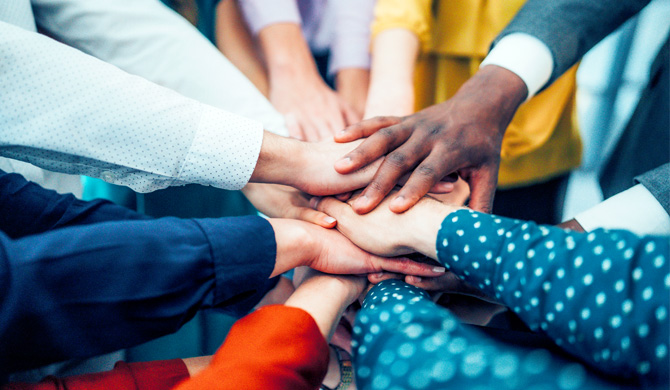Diverse creative team representing Bourn Creative with all hands in on a new project