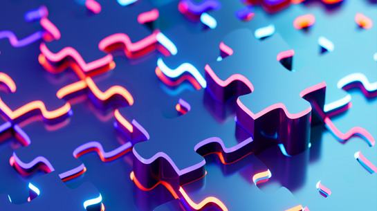 Blue puzzle pieces with neon pink and orange edges, representing the partnership between Bourn Creative and it's clients