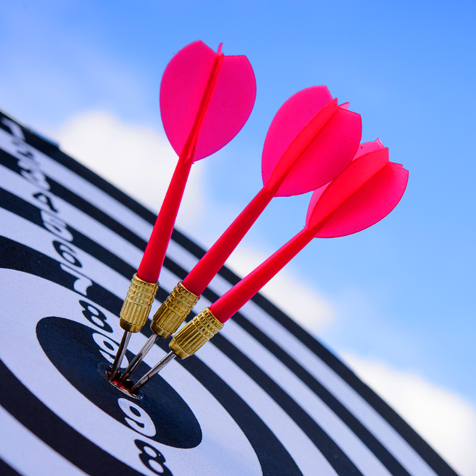 Three neon fuschia darts in the bullseye for a perfect-fit-client