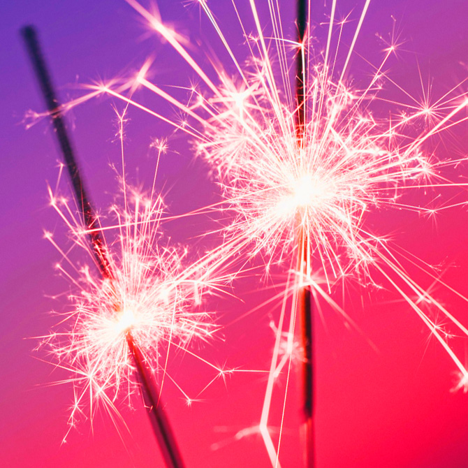 Two sparklers making magic, like how great partnerships create the magic of great brands, against a pink and purple background