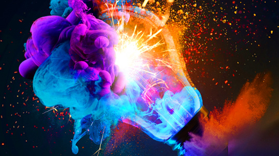 A light bulb exploding with rainbow sparks and dust clouds representing discoverability of brands through search and AI visibility