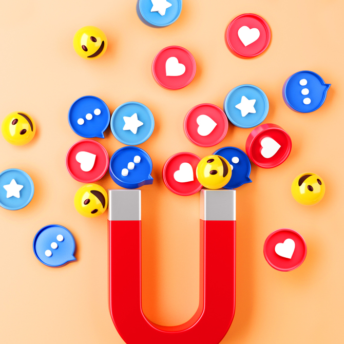 A magnet pulling happy faces, hearts, and speech bubbles toward it like well-designed brand assets and marketing materials attract clients and customers