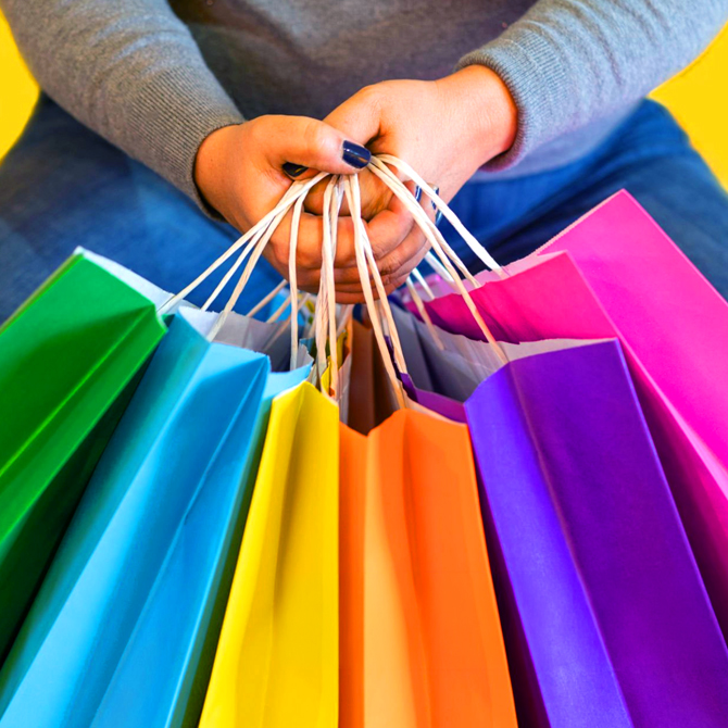 Writing Pre-Sale Content is like pre-filling the all the colorful shopping bags this woman is casual clothes is holding in front of her