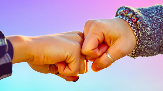 A content marketing agency partner bumping fists with a client