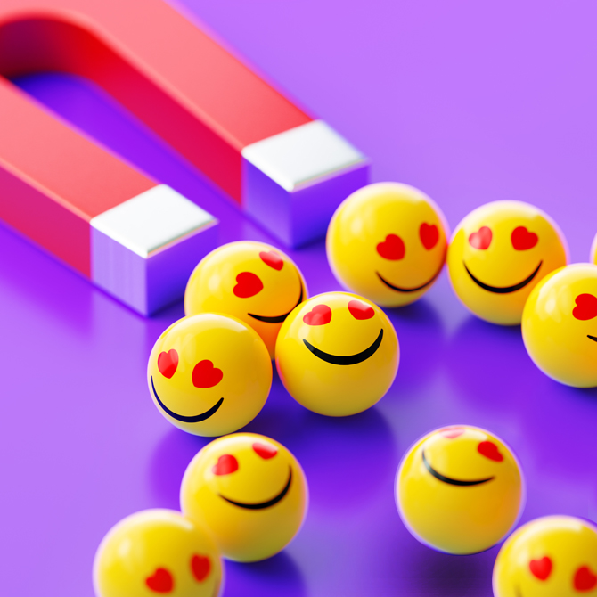 A red and silver u-shaped magnet pulling bright yellow happy face balls toward it like a lead magnet pulls leads to your offer